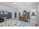 Cozy bedroom with blue accent wall, neutral colors, and an ensuite bathroom visible through an open doorway at 2993 Club Dr, Raleigh, NC 27613