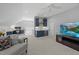 Open floorplan bonus room with wet bar, tv, neutral walls, plush carpet and desk area at 2993 Club Dr, Raleigh, NC 27613