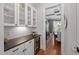 Butler's pantry featuring wine cooler, counter space, and glass-front cabinets at 2993 Club Dr, Raleigh, NC 27613