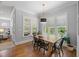 Bright dining room with hardwood floors, large windows, pendant lighting, and seating for six at 2993 Club Dr, Raleigh, NC 27613