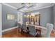 Elegant dining room with coffered ceiling, stylish chandelier, and ample seating at 2993 Club Dr, Raleigh, NC 27613