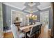 Bright dining room with hardwood floors, a large table, and plenty of natural light at 2993 Club Dr, Raleigh, NC 27613