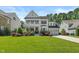 Charming two-story white home featuring a welcoming front porch and well-manicured lawn at 2993 Club Dr, Raleigh, NC 27613