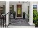 Charming front door with stone entryway, decorative plants, and sidelight windows at 2993 Club Dr, Raleigh, NC 27613