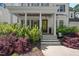 Charming home exterior featuring a covered front porch, manicured landscaping and a beautiful front door at 2993 Club Dr, Raleigh, NC 27613