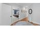 Hallway with hardwood floors and framed art, leading to a bedroom and bathroom at 2993 Club Dr, Raleigh, NC 27613