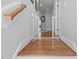 A well-lit hallway with hardwood floors and a safety gate is featured, connecting different areas of the home at 2993 Club Dr, Raleigh, NC 27613