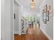 Inviting hallway with hardwood floors leading to the living room and staircase at 2993 Club Dr, Raleigh, NC 27613