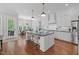 Modern kitchen with stainless steel appliances, island with seating, and hardwood floors at 2993 Club Dr, Raleigh, NC 27613