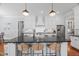 Kitchen island with seating, stainless steel appliances, and modern pendant lighting at 2993 Club Dr, Raleigh, NC 27613