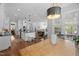 Bright, open kitchen, dining, and living area with white cabinetry and hardwood floors at 2993 Club Dr, Raleigh, NC 27613