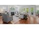 Bright living room with hardwood floors, fireplace, and large windows at 2993 Club Dr, Raleigh, NC 27613