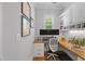 A functional office with built-in shelving, under cabinet lighting, a large desk, and views to the exterior at 2993 Club Dr, Raleigh, NC 27613