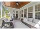 Inviting screened porch featuring comfortable seating, a ceiling fan, a wood ceiling and views of the surrounding landscape at 2993 Club Dr, Raleigh, NC 27613