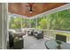 Inviting screened porch featuring comfortable seating, a ceiling fan, a wood ceiling and views of the surrounding landscape at 2993 Club Dr, Raleigh, NC 27613