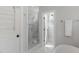 Elegant shower with marble tile surround, glass door, and rainfall shower head at 2993 Club Dr, Raleigh, NC 27613