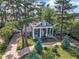 Aerial view of home with manicured lawn, trees, and elegant front porch at 300 S Pine St, Benson, NC 27504