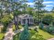 Aerial view of home surrounded by mature trees, manicured lawn, and circular driveway at 300 S Pine St, Benson, NC 27504