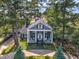 Aerial view of home with inviting porch, mature trees, and circular driveway at 300 S Pine St, Benson, NC 27504