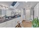 Bathroom featuring a skylight, double vanity, shower, and elegant fixtures and decor at 300 S Pine St, Benson, NC 27504