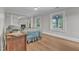 Cozy bedroom featuring windows, hardwood floors, and a fireplace in an open, shared room at 300 S Pine St, Benson, NC 27504