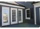 View of the deck with multiple doors at 300 S Pine St, Benson, NC 27504