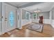 Bright entryway featuring hardwood floors, decorative rug, and a stained glass door at 300 S Pine St, Benson, NC 27504