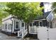 Charming two-story home with a sunroom, deck, and a beautifully landscaped yard at 300 S Pine St, Benson, NC 27504