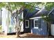 Exterior side view of home with mature landscaping and covered patio at 300 S Pine St, Benson, NC 27504