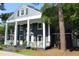 Charming two-story home with a covered porch and mature trees at 300 S Pine St, Benson, NC 27504