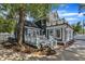 Beautiful exterior with deck access, mature trees, and manicured landscaping at 300 S Pine St, Benson, NC 27504