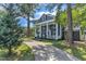 Traditional two-story home with a long driveway, mature trees, and a well-manicured front yard at 300 S Pine St, Benson, NC 27504