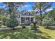 Charming two-story home with classic architectural details and manicured front lawn and garden at 300 S Pine St, Benson, NC 27504