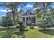 Classic two-story home with inviting front porch, lush greenery, and well-maintained lawn at 300 S Pine St, Benson, NC 27504