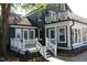 Exterior back of home with deck, covered porch and manicured yard at 300 S Pine St, Benson, NC 27504