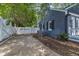 Exterior view of home with painted brick, white fence, and concrete driveway at 300 S Pine St, Benson, NC 27504