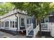 Charming two-story home with a sunroom and deck surrounded by mature trees at 300 S Pine St, Benson, NC 27504