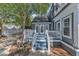 Charming home featuring blue accent deck with stairs, railings, and a garden statue at 300 S Pine St, Benson, NC 27504