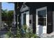Cozy front porch featuring wicker furniture, potted plants, and decorative accents at 300 S Pine St, Benson, NC 27504