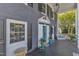 Covered porch featuring black shutters, window boxes, and comfortable patio furniture at 300 S Pine St, Benson, NC 27504