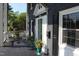 Comfortable porch with wicker seating, potted plants, and a dark painted floor at 300 S Pine St, Benson, NC 27504