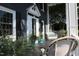 Relaxing porch with wicker seating, decorative potted plants, and porch accents at 300 S Pine St, Benson, NC 27504