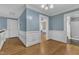 Hallway featuring wainscotting, hardwood floors, and entryways to adjacent rooms at 300 S Pine St, Benson, NC 27504