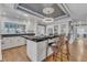 Beautiful kitchen with a large island, barstool seating, modern lighting, white cabinets and hardwood floors at 300 S Pine St, Benson, NC 27504