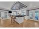 Spacious kitchen with a large island, barstool seating, modern appliances, and hardwood floors at 300 S Pine St, Benson, NC 27504
