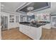 Spacious kitchen with a large island, modern appliances, white cabinets and hardwood floors at 300 S Pine St, Benson, NC 27504