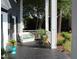 Inviting porch featuring wicker furniture, potted plants, and a peaceful outdoor setting at 300 S Pine St, Benson, NC 27504