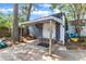 View of the shed in the backyard with covered area and concrete base at 300 S Pine St, Benson, NC 27504