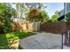 Private backyard with a brick fence, wooden fence, and small storage shed at 3029 Wycliff Rd, Raleigh, NC 27607