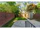 Fenced backyard with a concrete patio, shed, and trees at 3029 Wycliff Rd, Raleigh, NC 27607